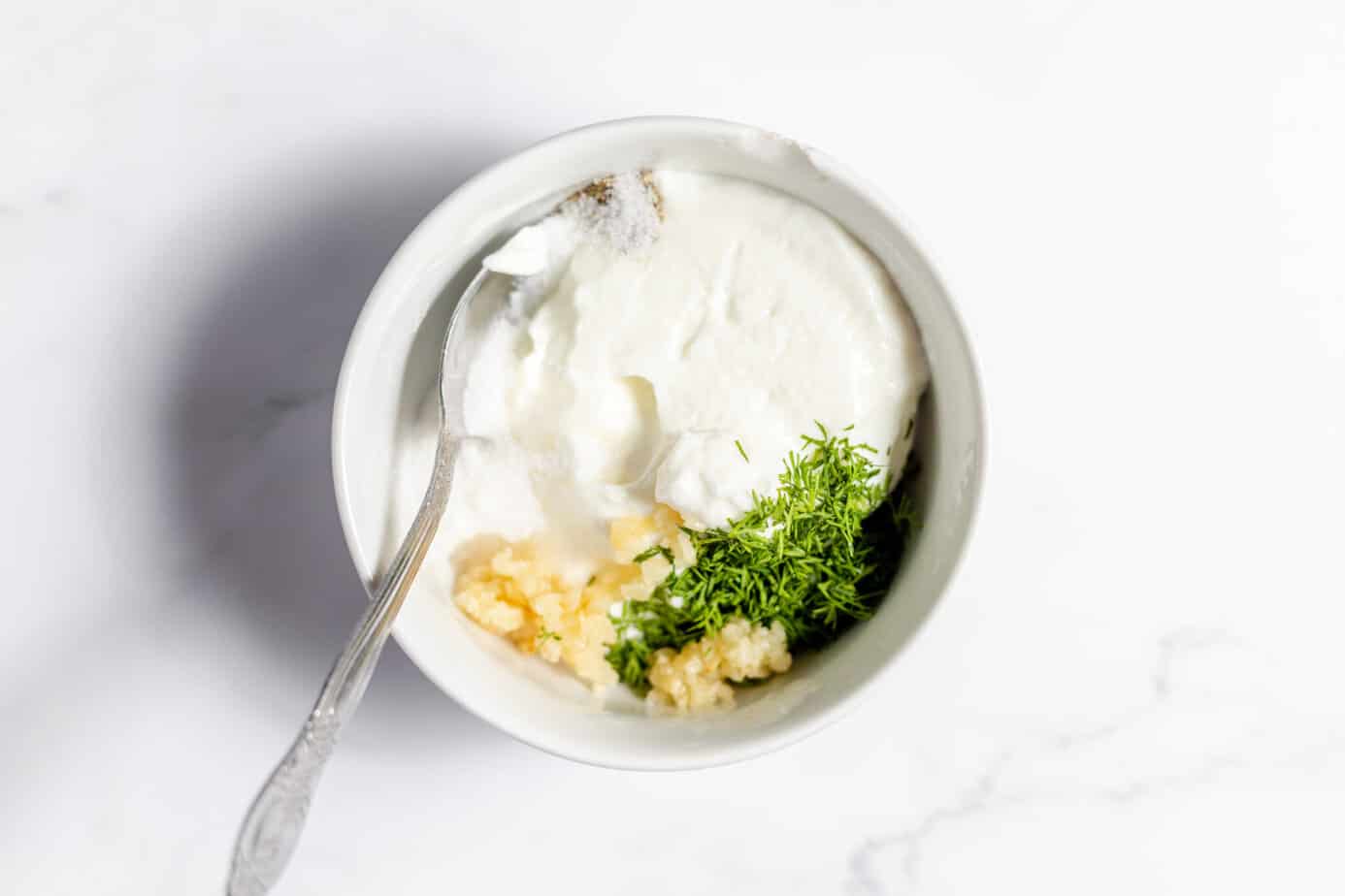 german salad dressing ingredients in a white bowl