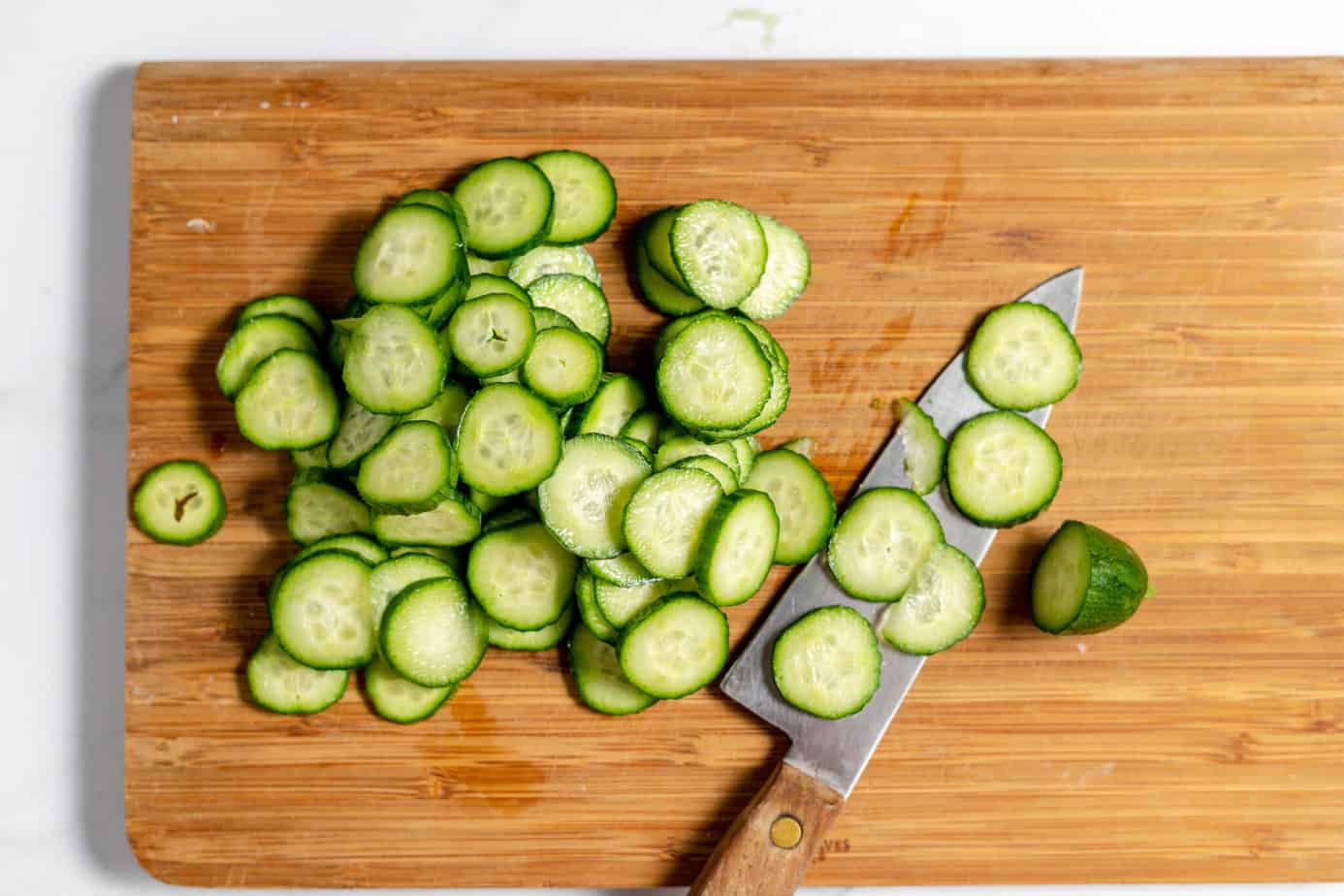sliced cucumbers on a cutting board