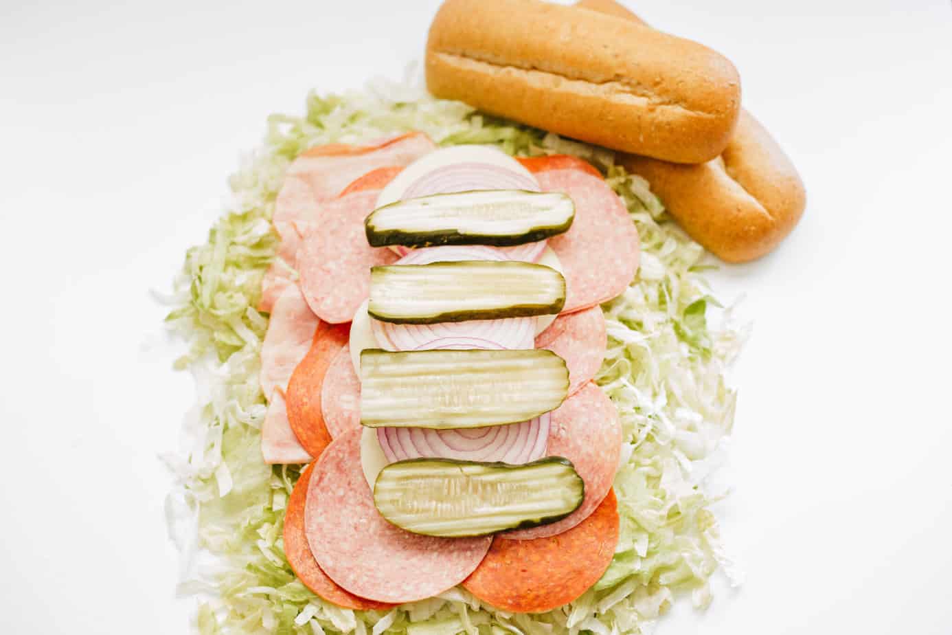 red onion and pickles added on top of the meats