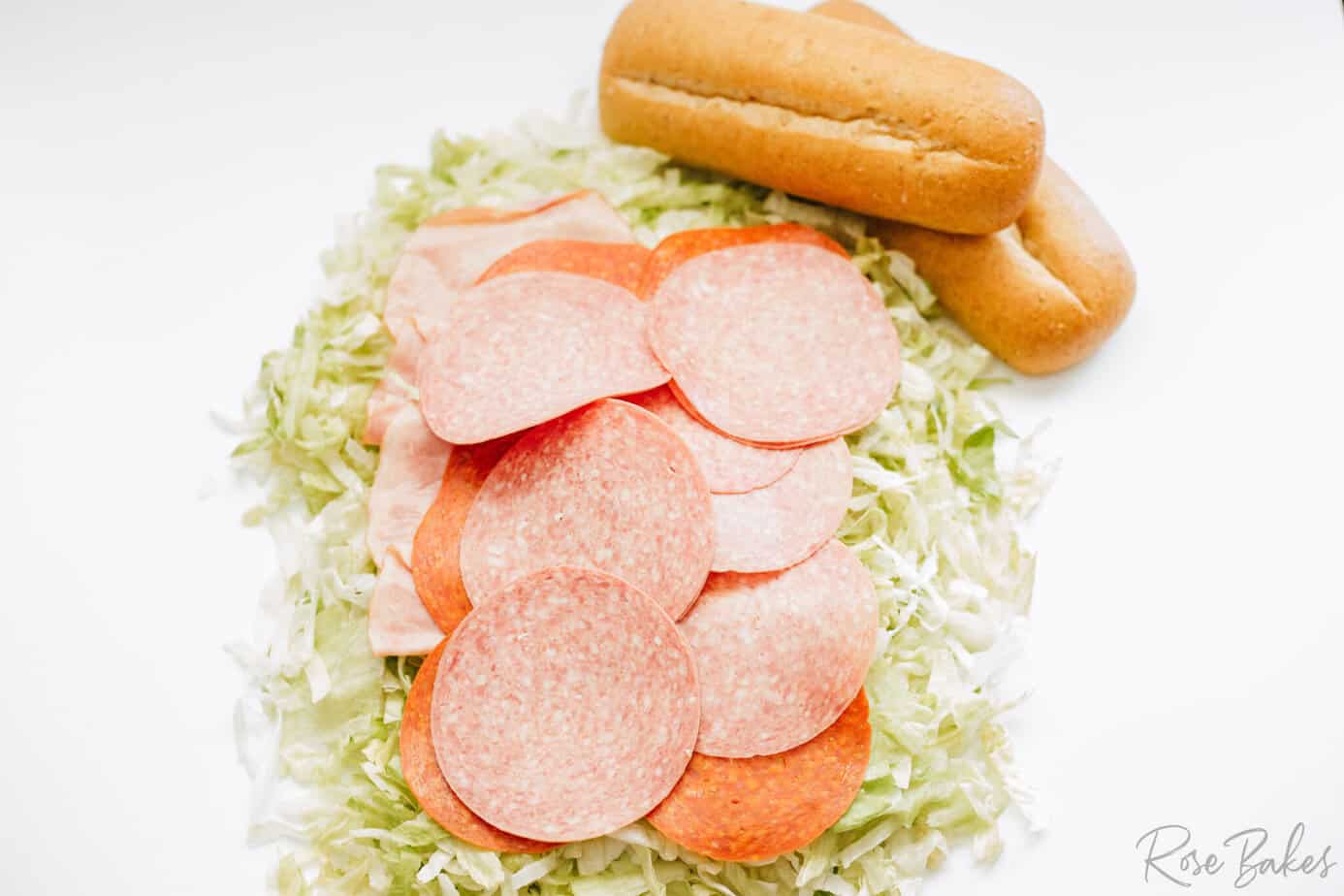 italian deli meats added on top of the lettuce