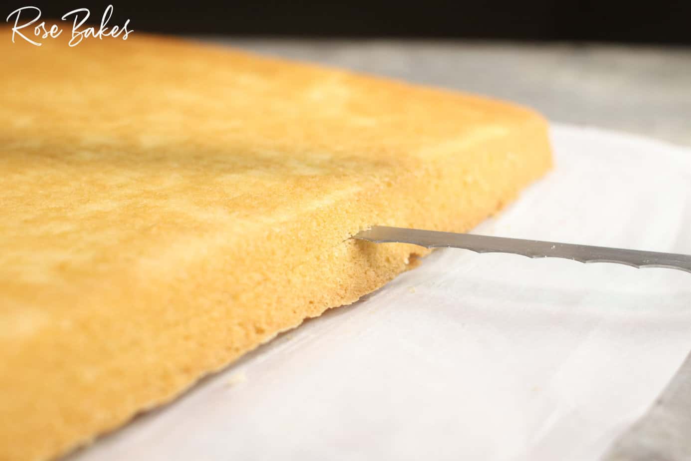 close up of the blade cutting the cake in half