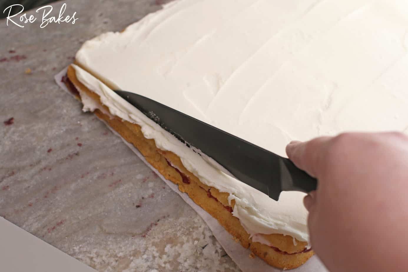 trimming the edged of the cake.