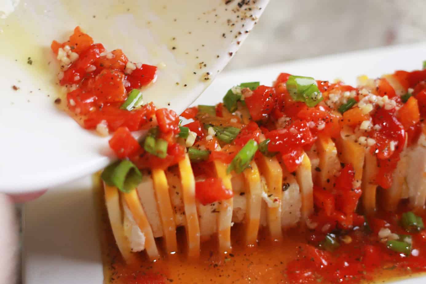 pouring marinade over sliced cheeses