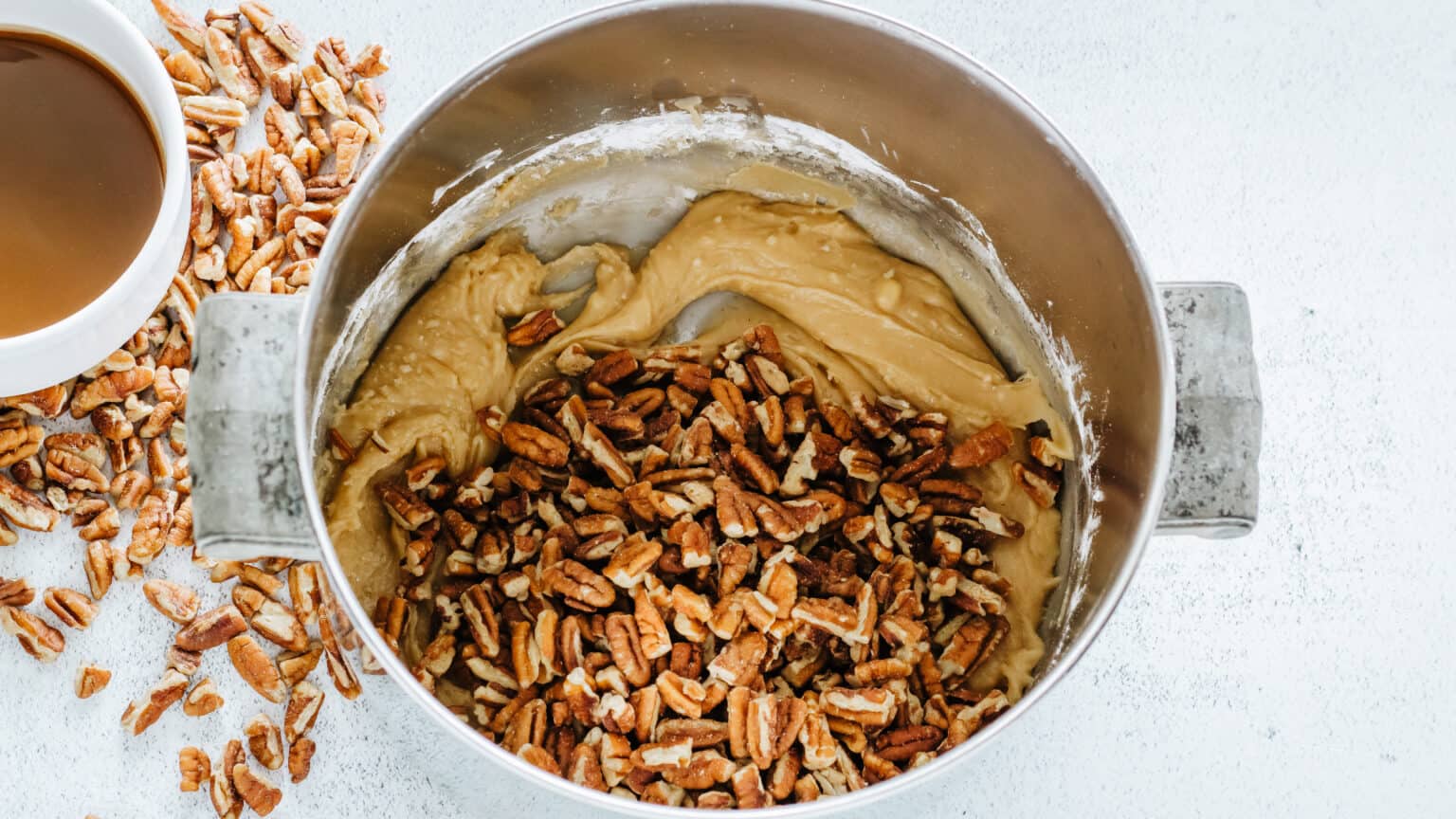 pecans with praline candy in saucepan