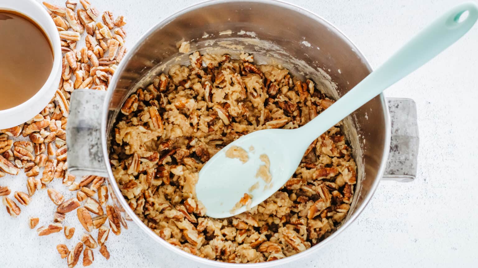 pecans with praline candy in saucepan