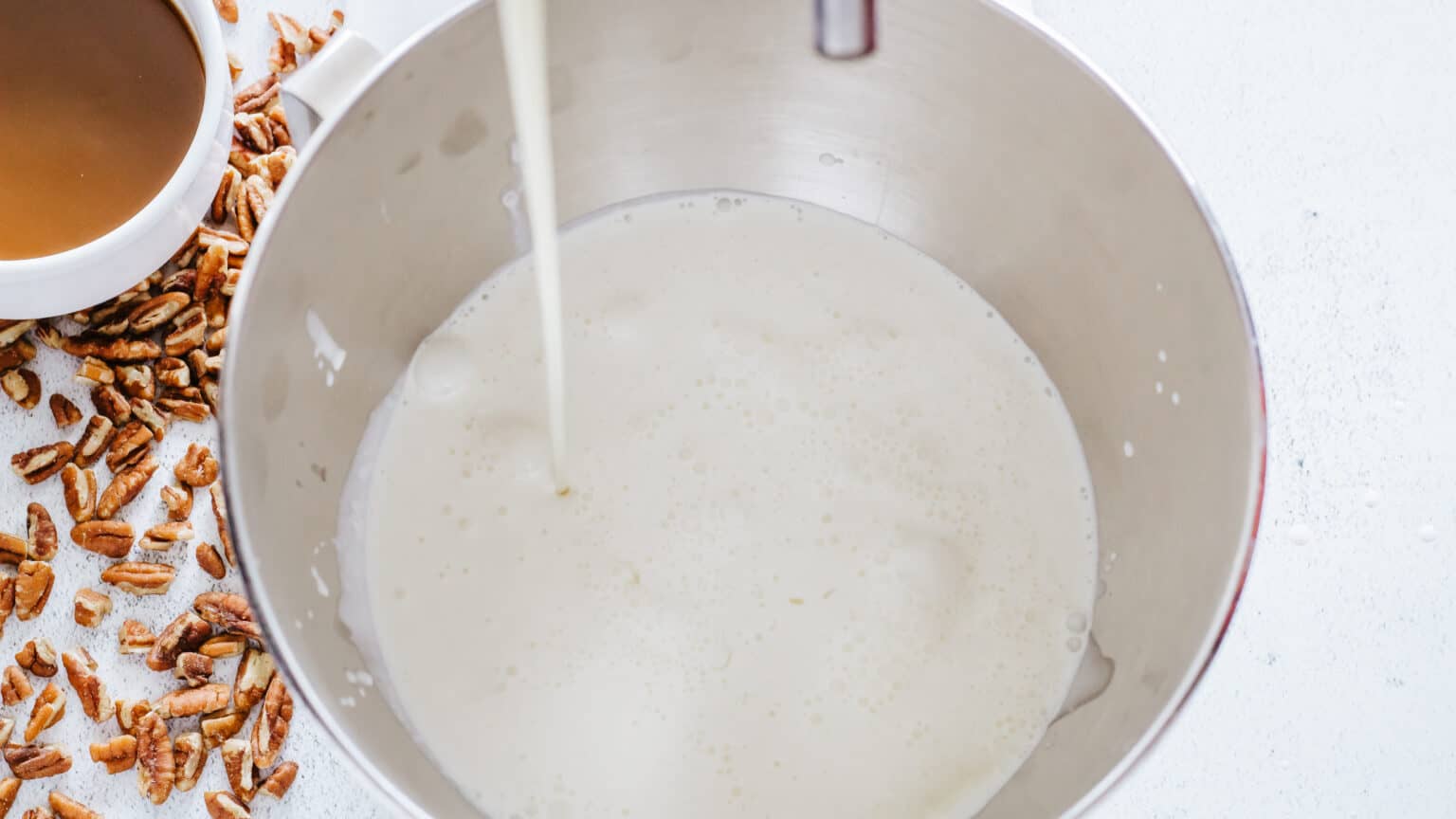 adding whipping cream, condensed milk, vanilla and salt to a mixer