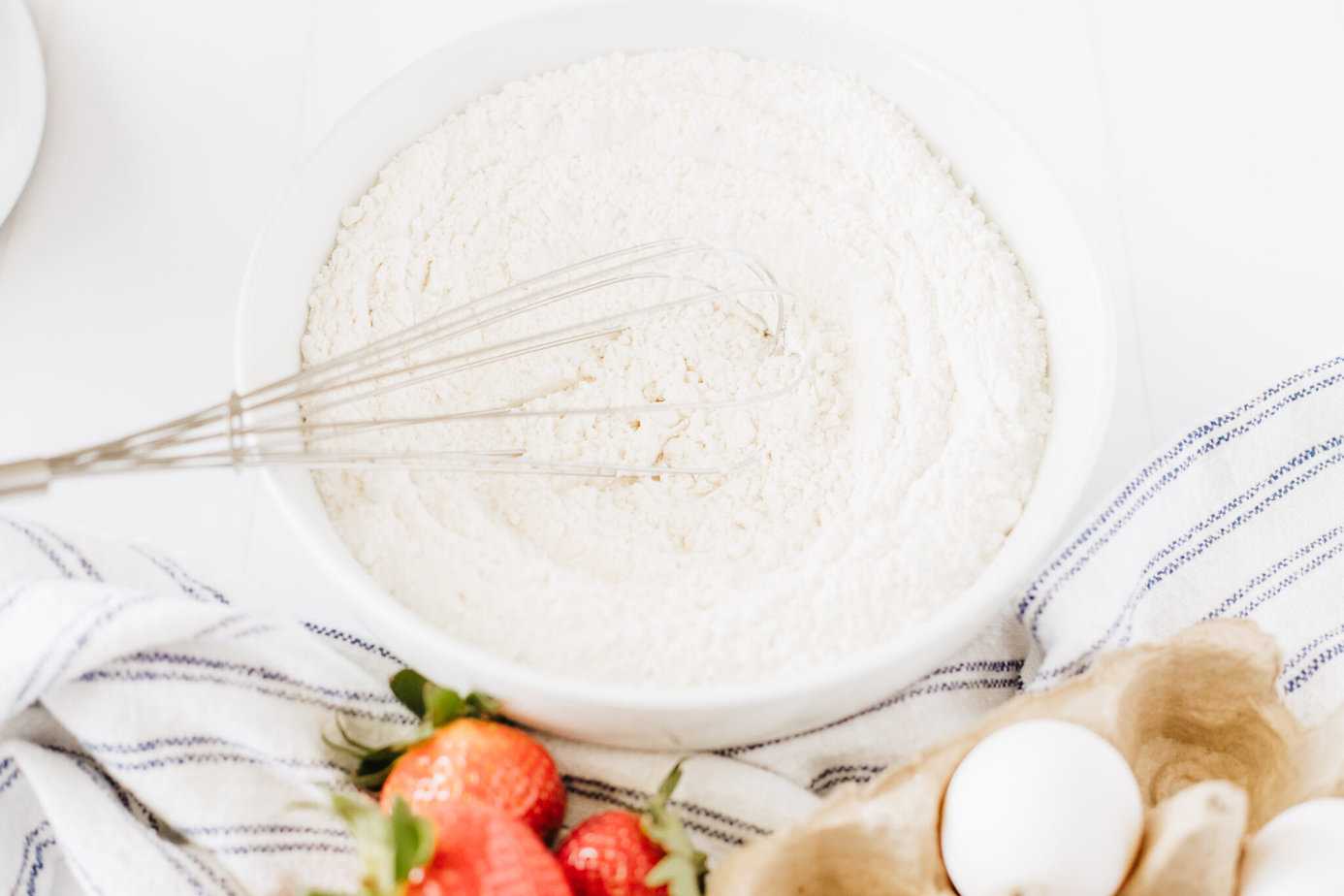 flour, sugar, baking powder, baking soda, and salt whisked together in a bowl