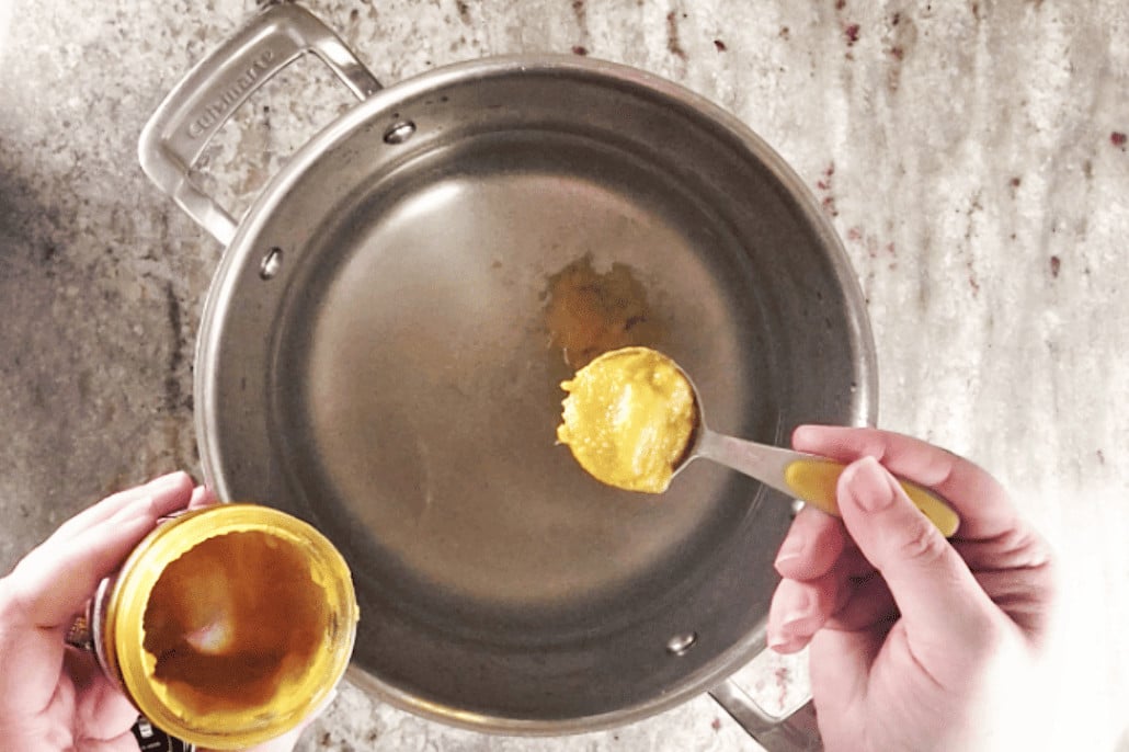 adding chicken base to soup pot