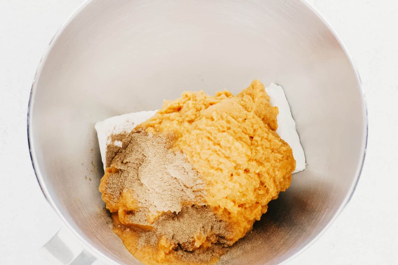 cream cheese, pumpkin pie spice, and pumpkin pie mix in a mixing bowl
