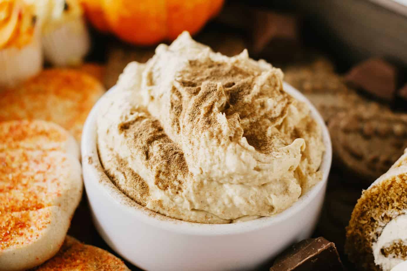 bowl of pumpkin cream cheese dip sprinkled with cinnamon on top