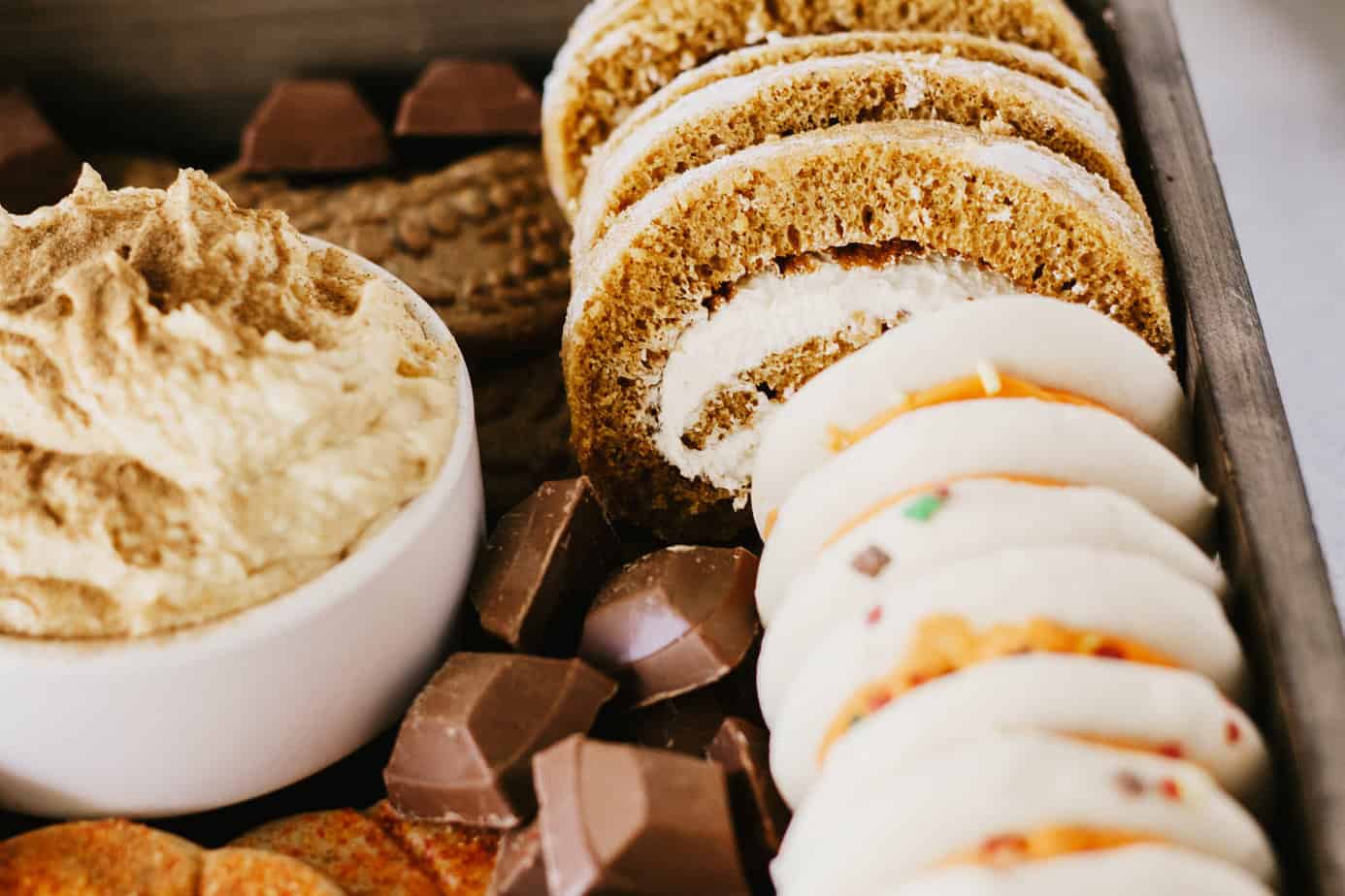 close up of the pumpkin roll added to the dessert board