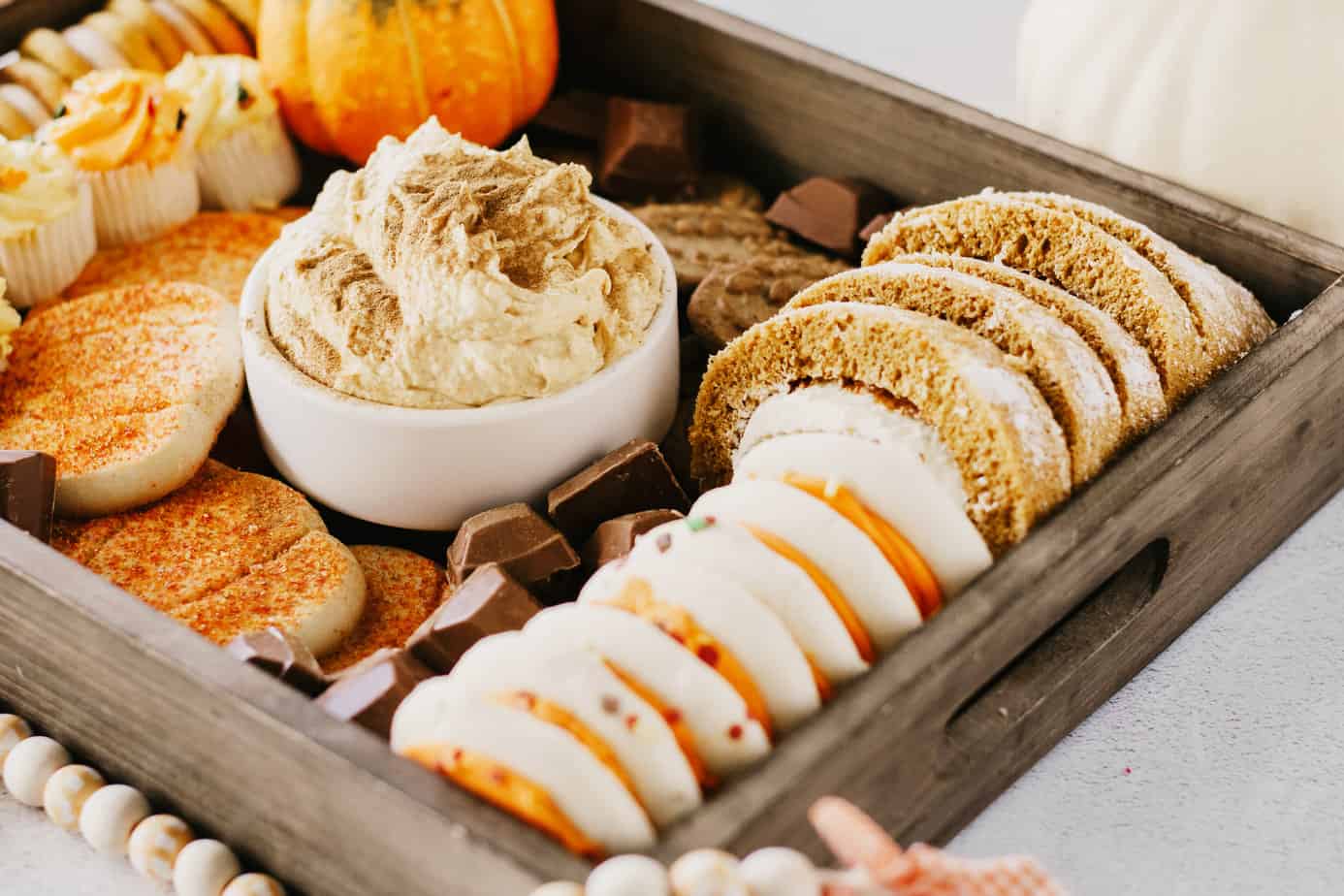 adding fall lofthouse sugar cookies to the dessert board.