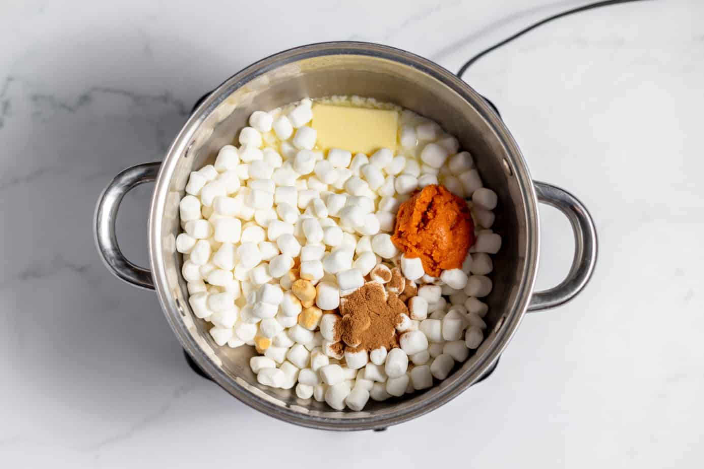 butter, pumpkin pie spice, pumpkin puree, vanilla, marshmallows and butter in a pan