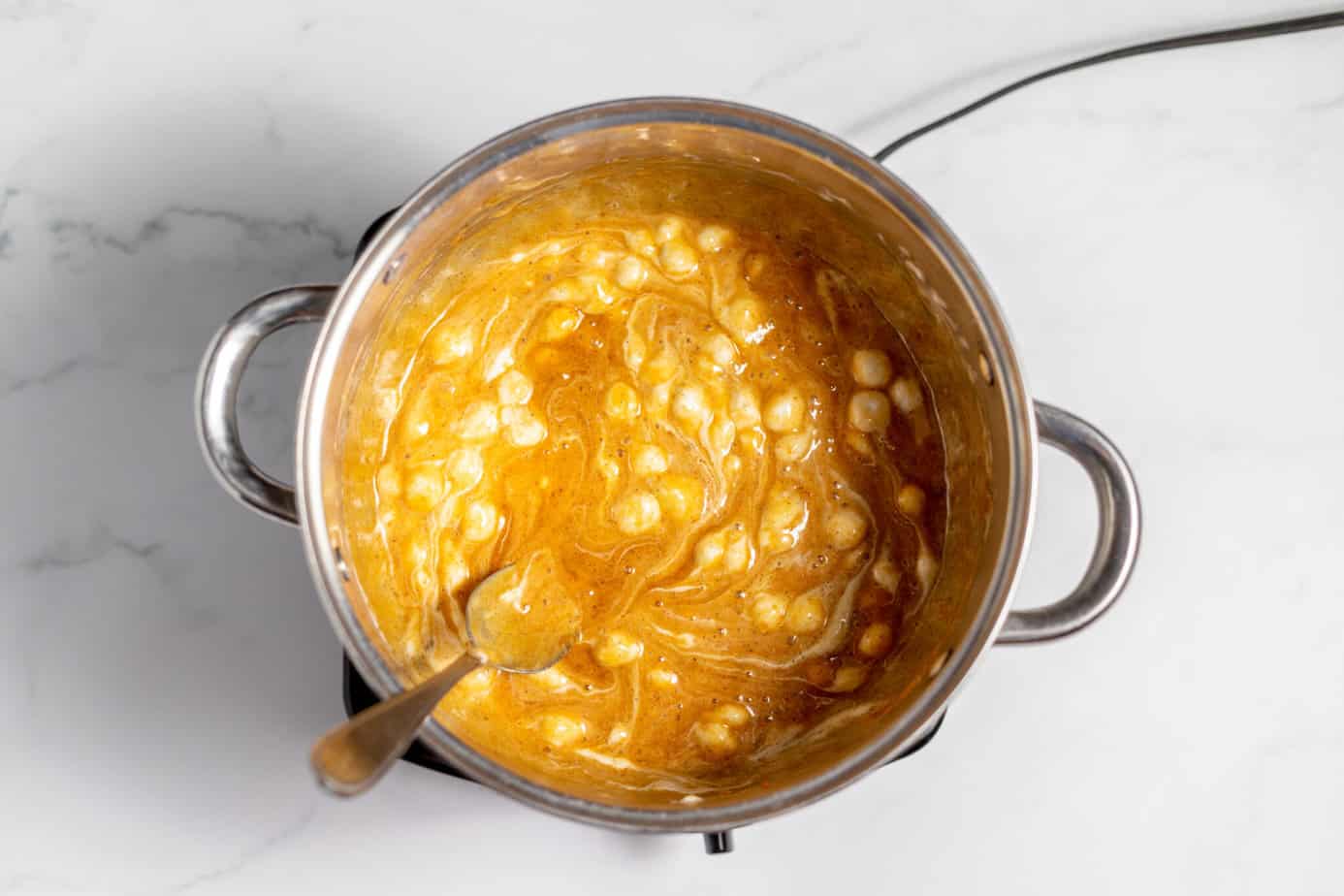 butter, pumpkin pie spice, pumpkin puree, vanilla, marshmallows and butter in a pan beginning to melt