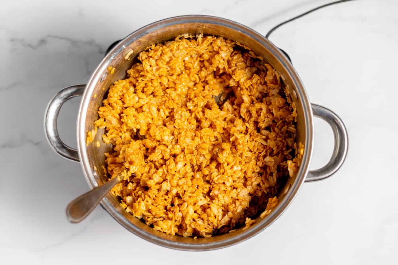 crispy rice cereal mixed into melted butter, pumpkin pie spice, pumpkin puree, vanilla, and marshmallows
