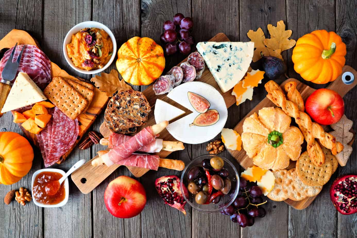 fall charcuterie boare filled with pumpkins and fall colors