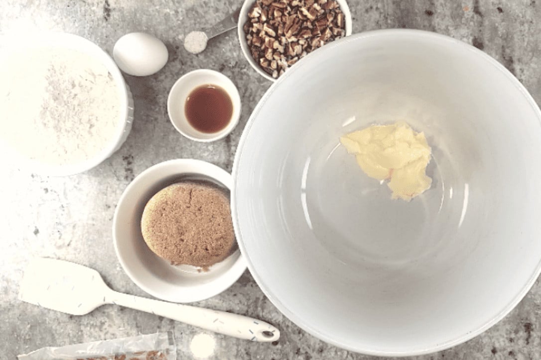praline cookie ingredients around a large white bowl