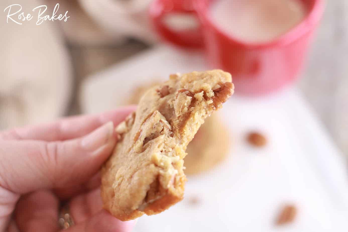 bite out of a praline cookie being held in one hand