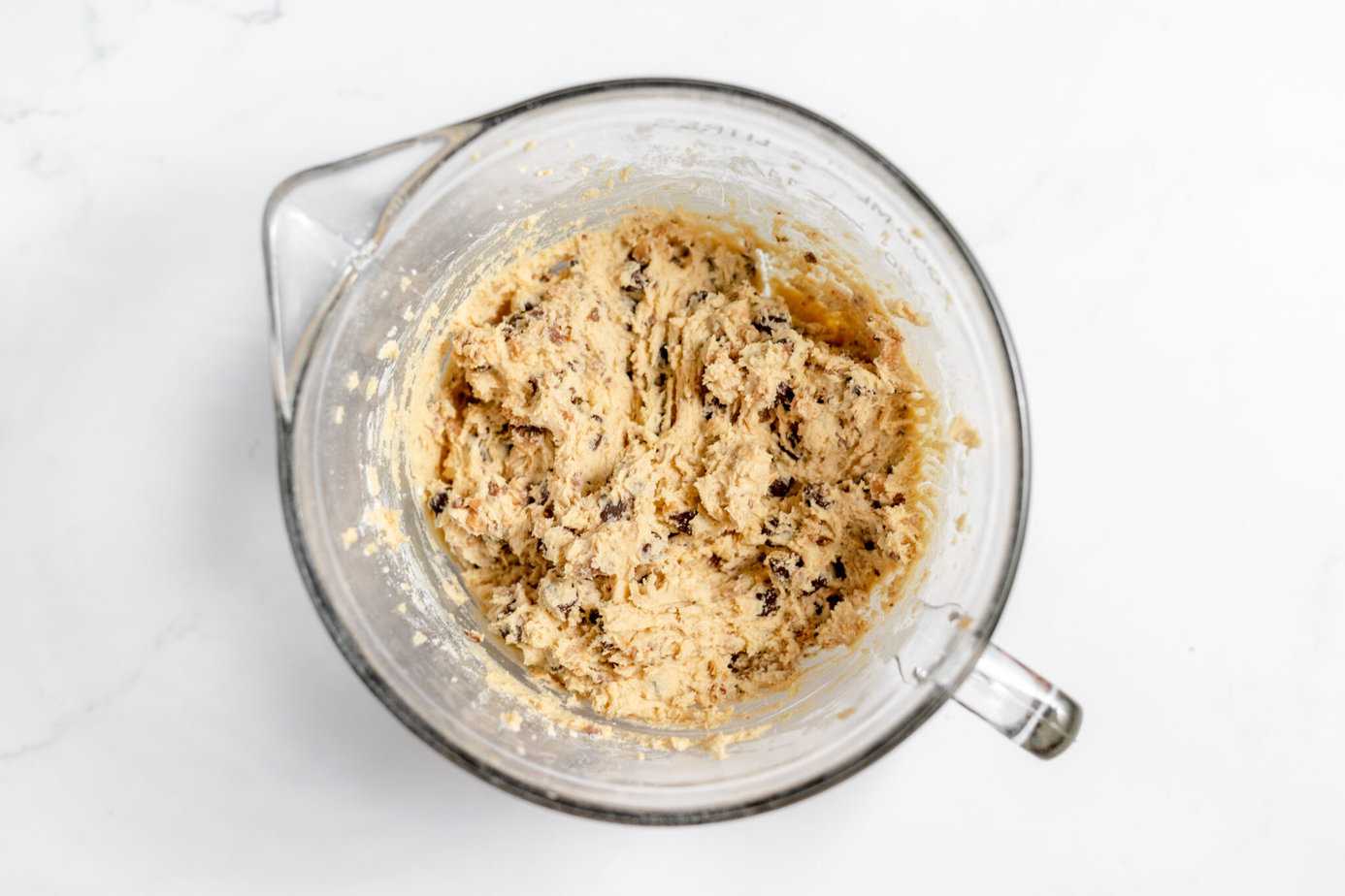 mixed up toffee chocolate chip cookie dough in mixing bowl