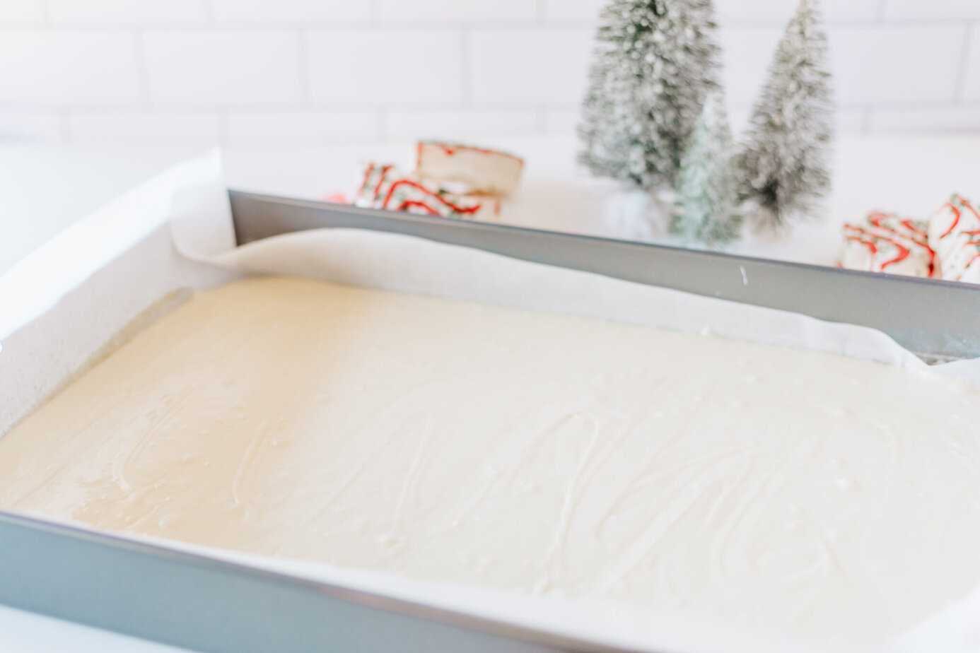 melted fudge mixture poured in pan linted with parchment paper