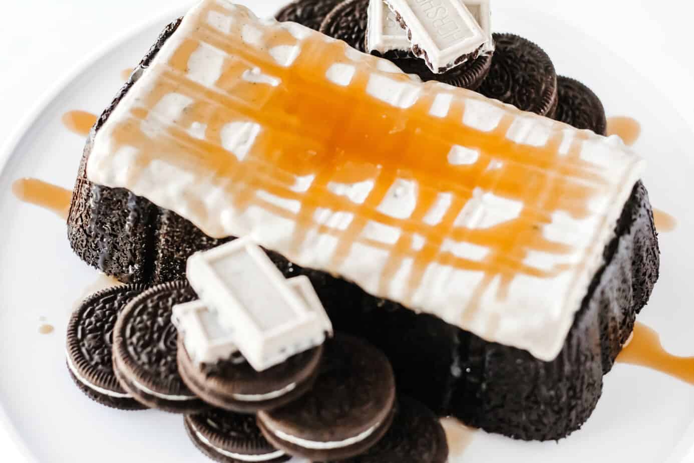 caramel sauce over melted XL cookies & creme candy bar on top of simple OREO Cake