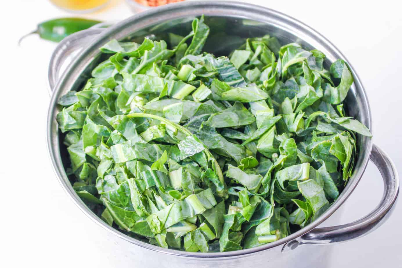 fresh collard greens chopped up and in a large pot