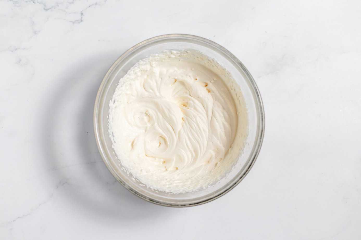 whipped cream in a clear bowl
