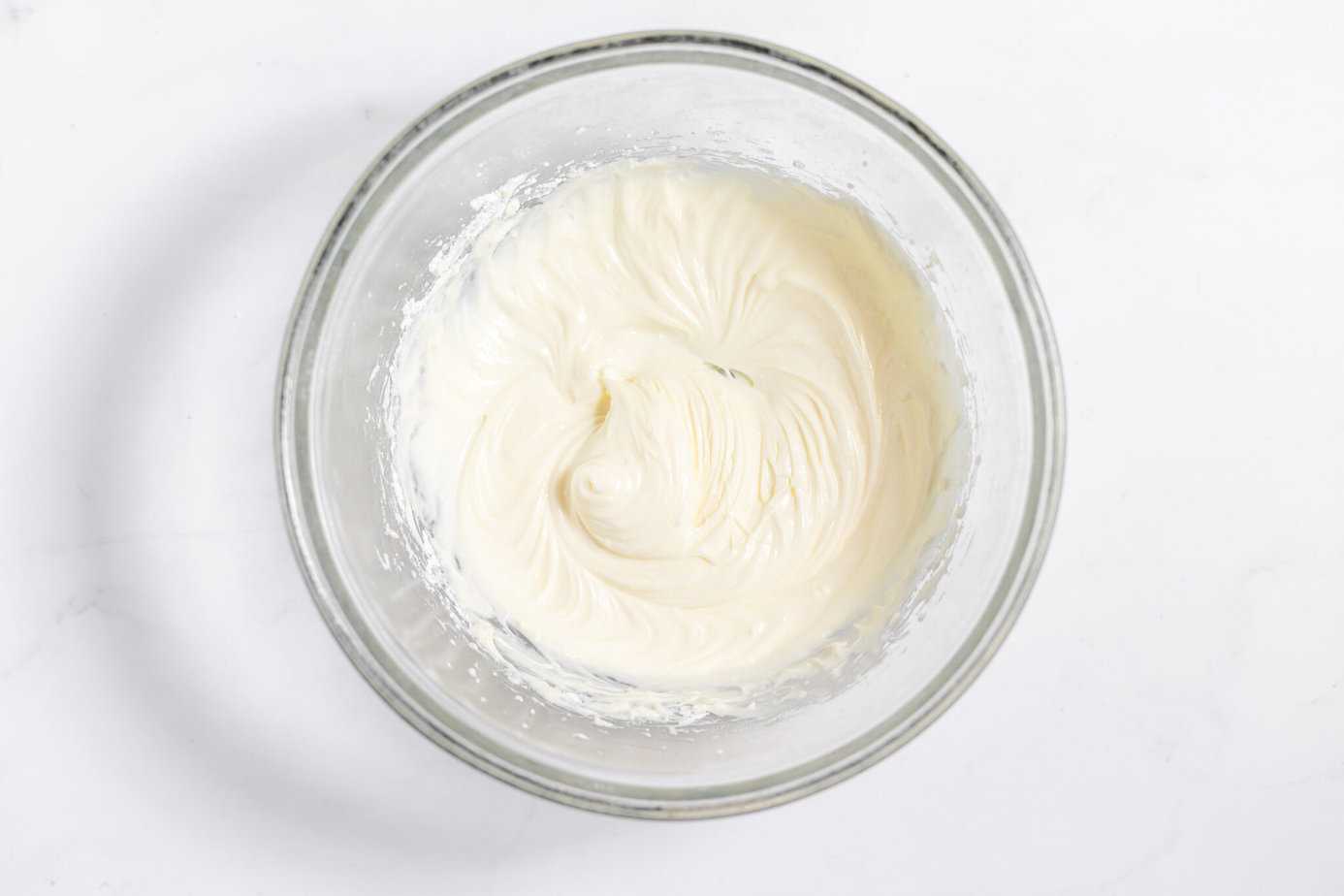 cream cheese, sour cream and powdered sugar in a bowl mixed up smooth