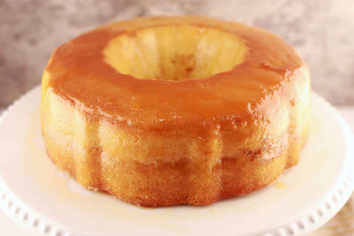 flan  leche cake on white cake stand
