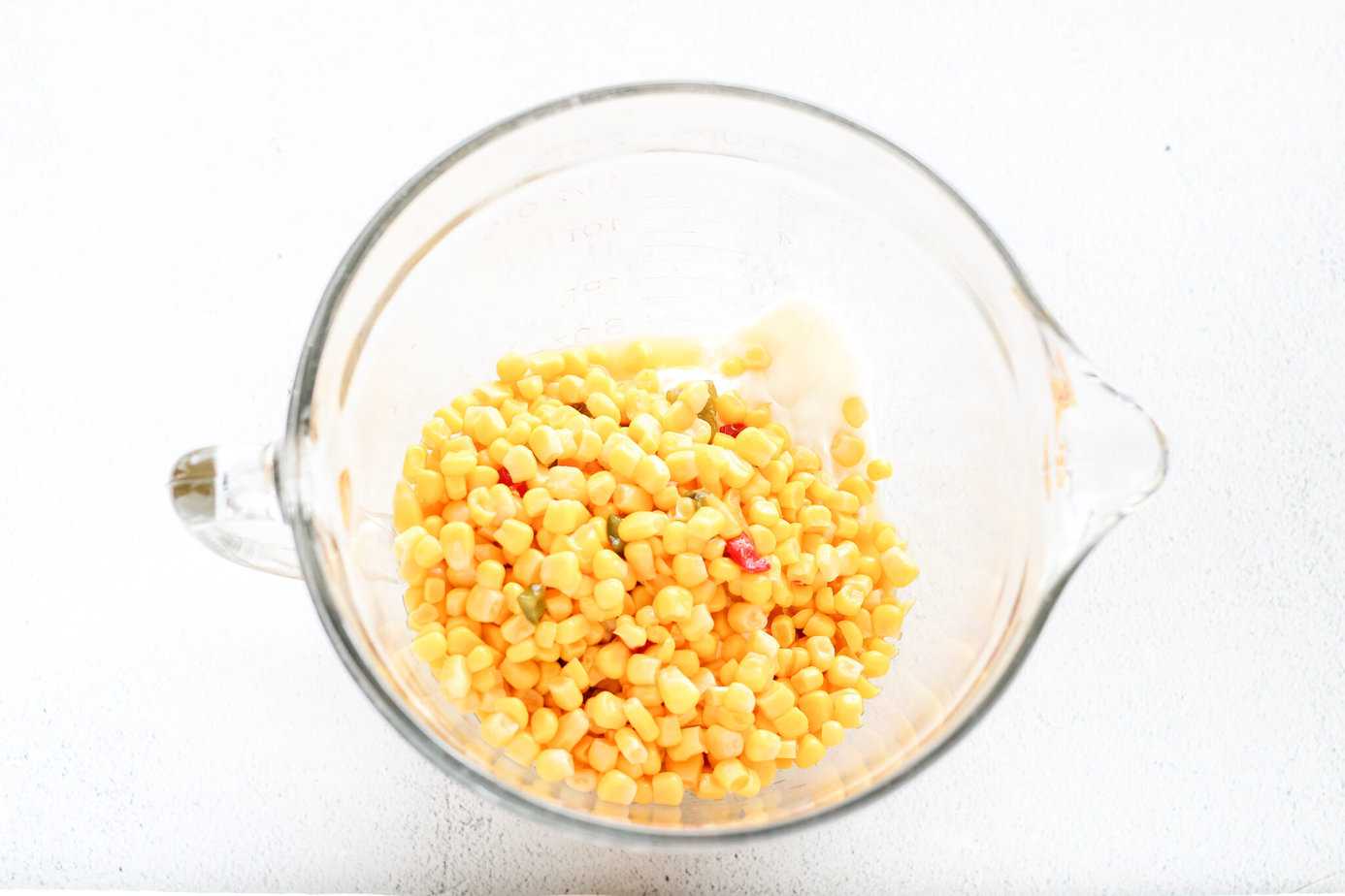 Rojos Street Corn Dip ingredients in a clear measuring bowl