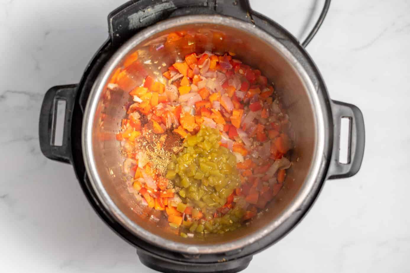 peppers onions and carrots in instant pot with seasonings added