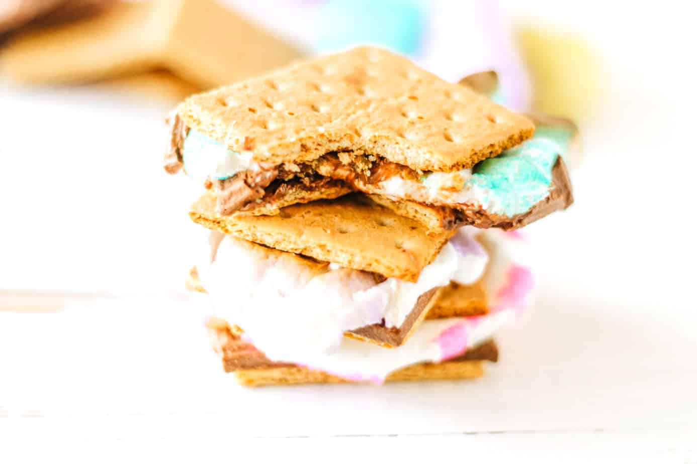 smores made with peeps stacked up with a bite missing