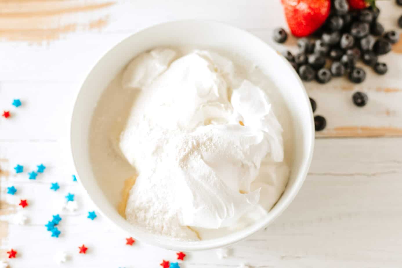cream cheese, pudding mix, creamer, cool whip, and vanilla extract in bowl
