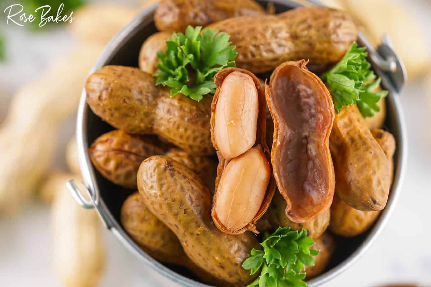 cracked open boiled peanut in a small bucket