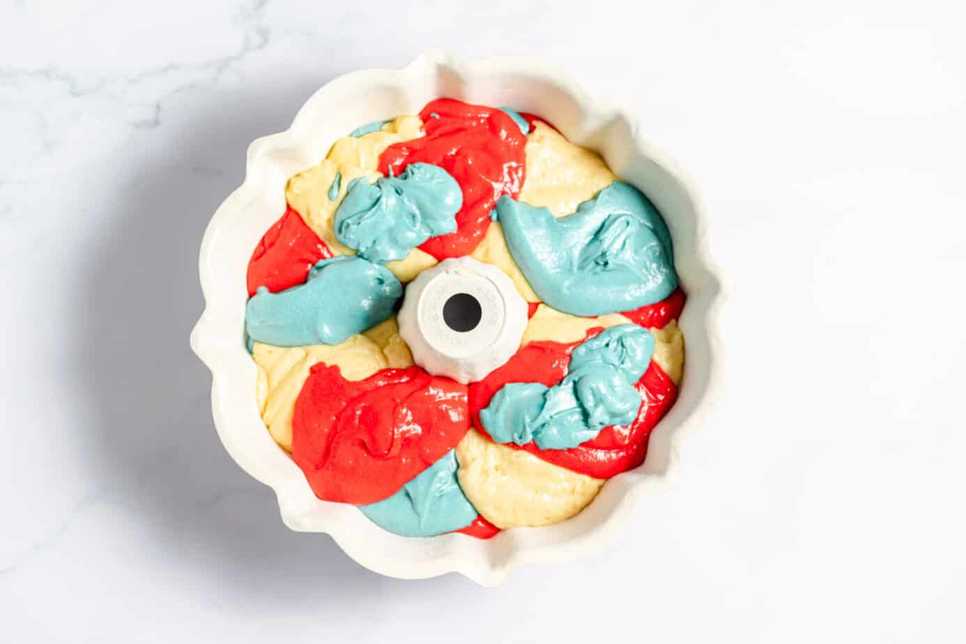 red white and blue cake batter in bundt pan
