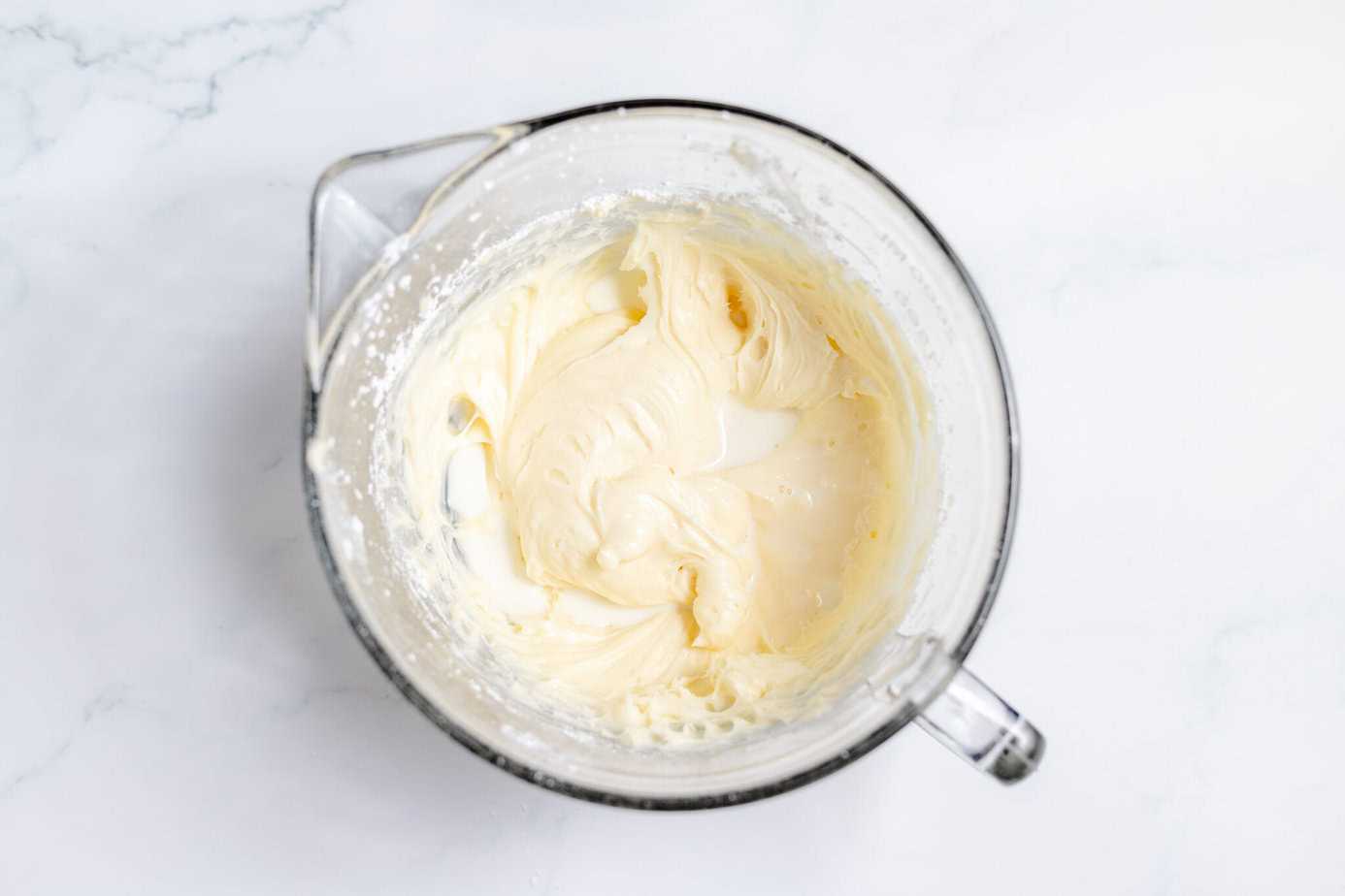 creamed cream cheese and butter in mixing bowl with milk