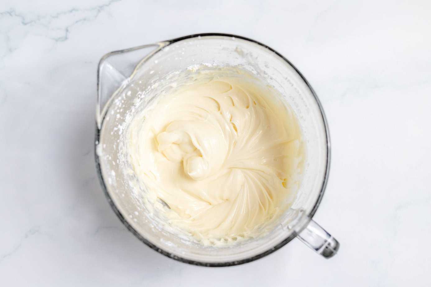 creamed cream cheese and butter in mixing bowl with powdered sugar