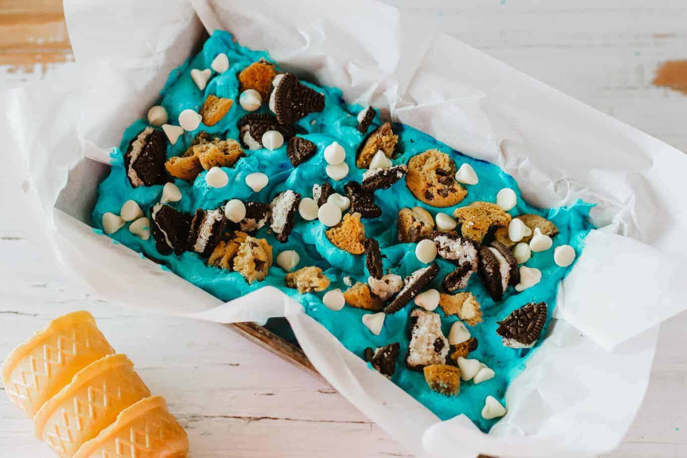 cookie monster ice cream spread in a loaf pan with cookie pieces on top