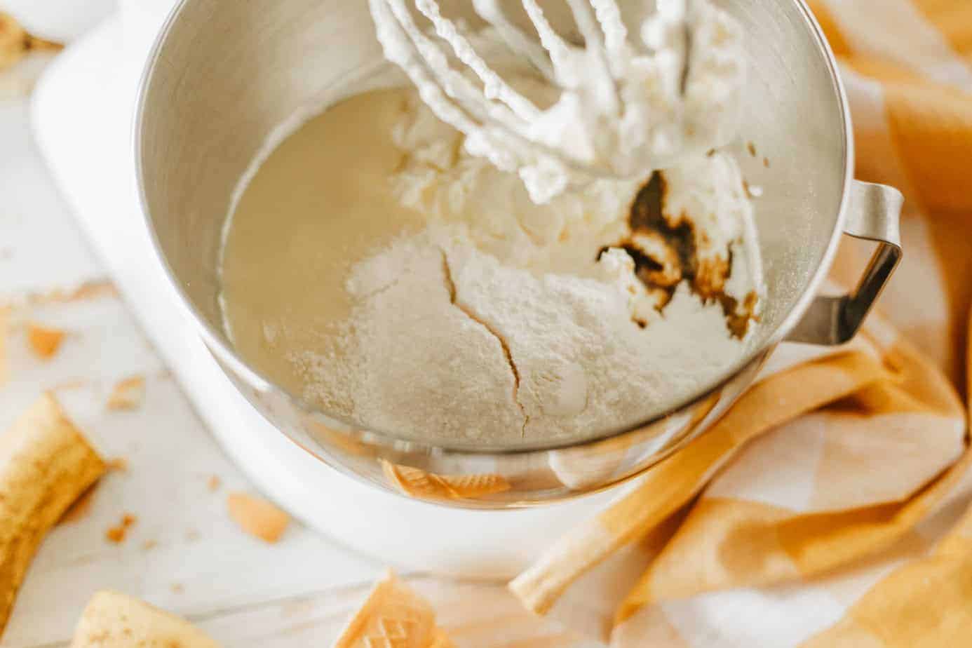 adding vanilla, condensed milk and pudding mix to the whipped cream