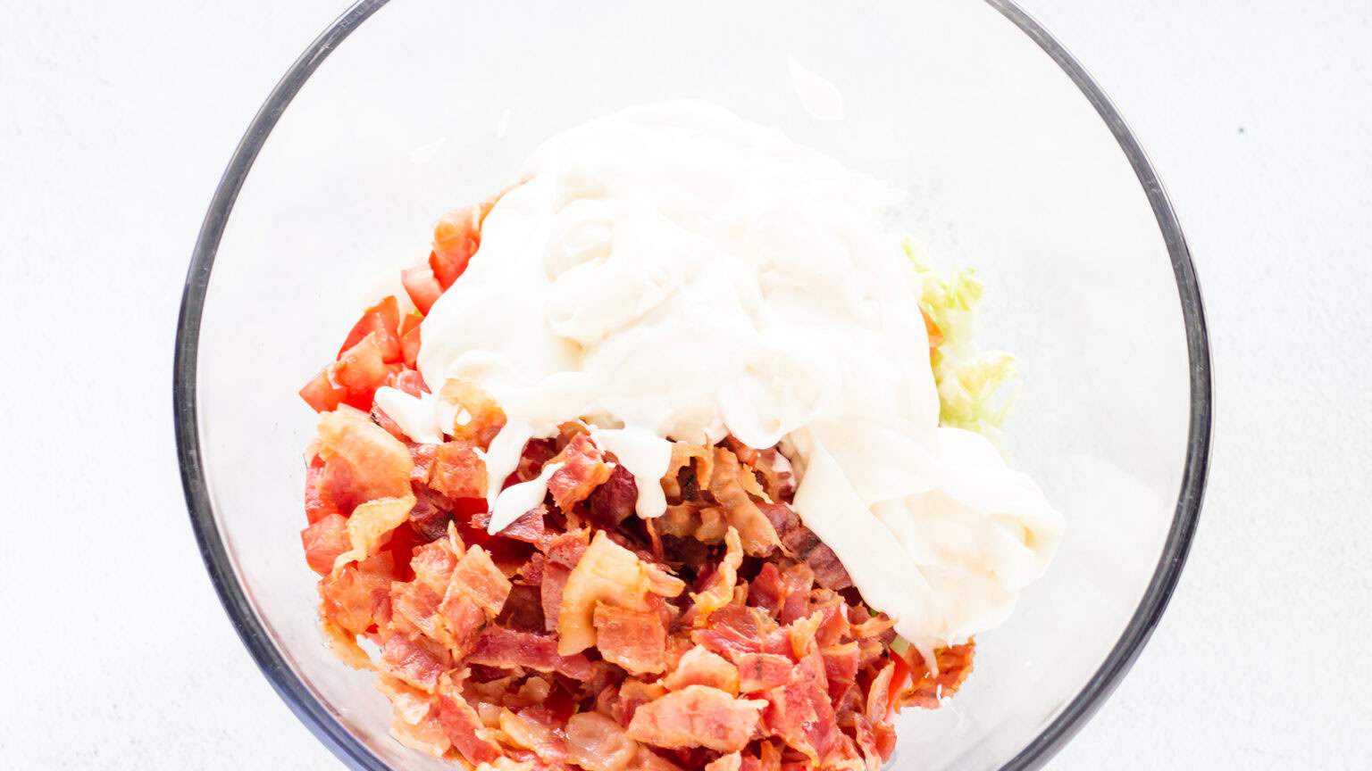 bacon lettuce and tomato in bowl with sour cream and mayo on top