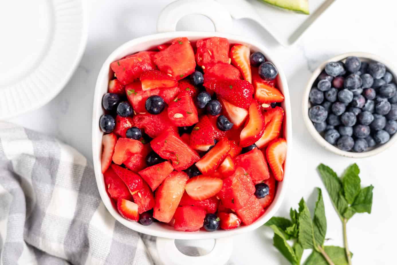 Serving dish filled with watermelon, strawberries, and blueberries.