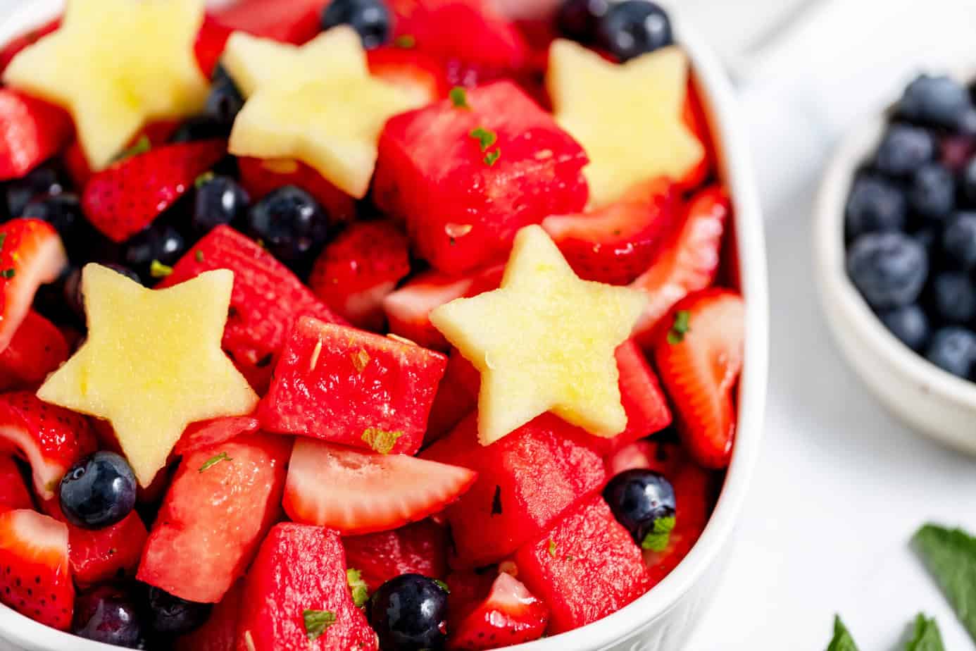 Close up view of the fruit tossed in mint lime dressing and topped with apple stars