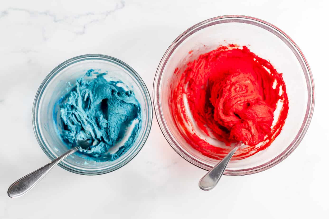two balls of cookie dough, one red and one blue
