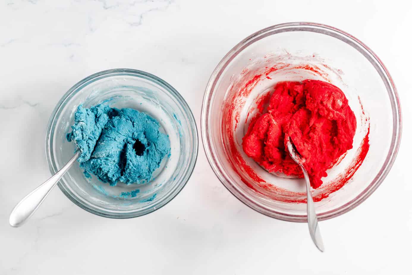 blue cookie dough and red cookie dough in separate bowls