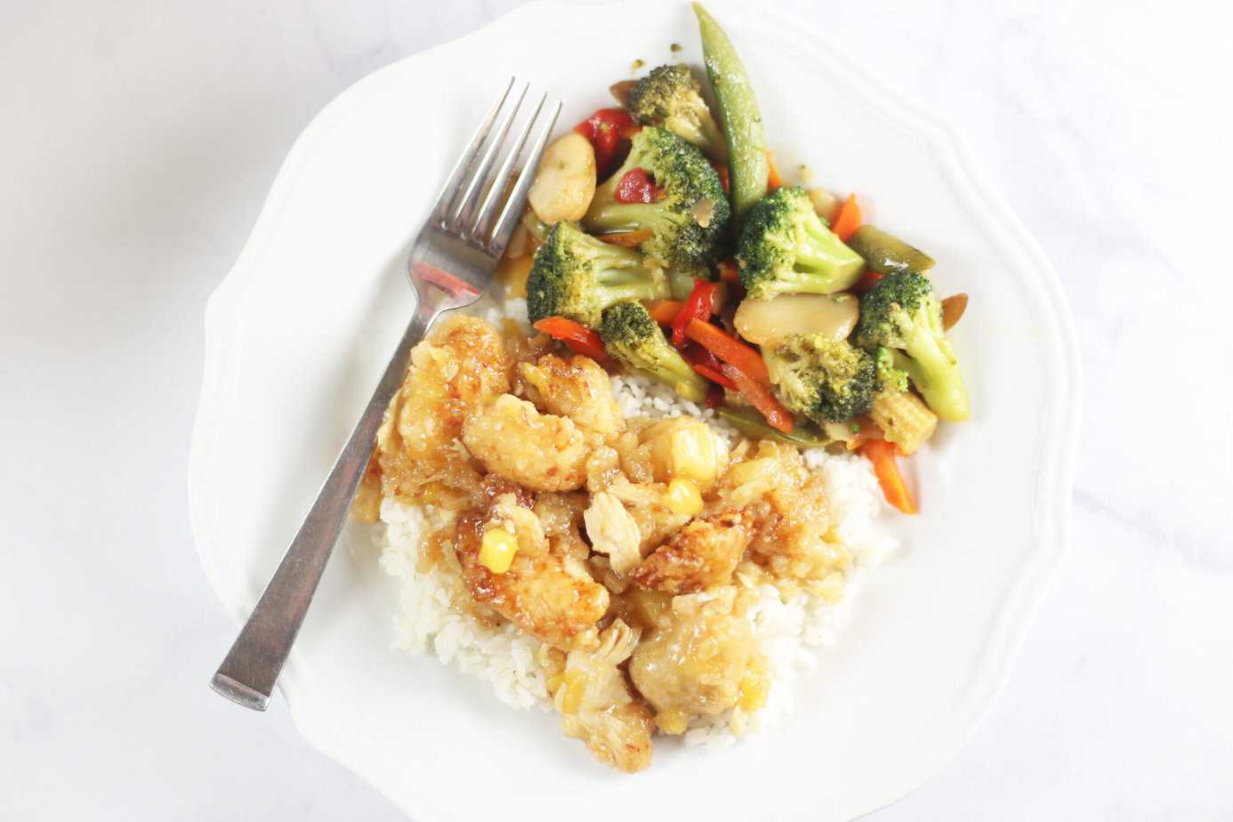 orange pineapple chicken over rice with veggies