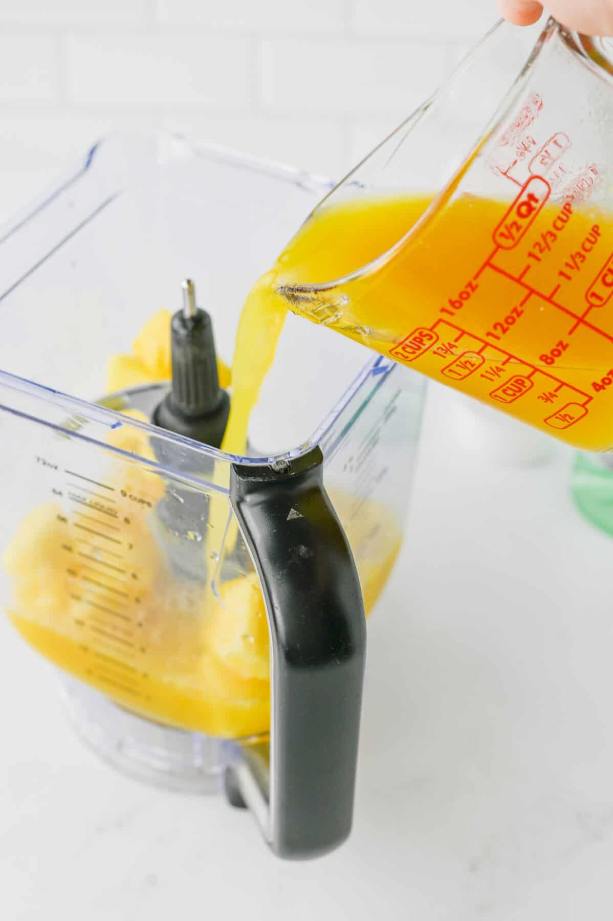 pouring pineapple juice in blender