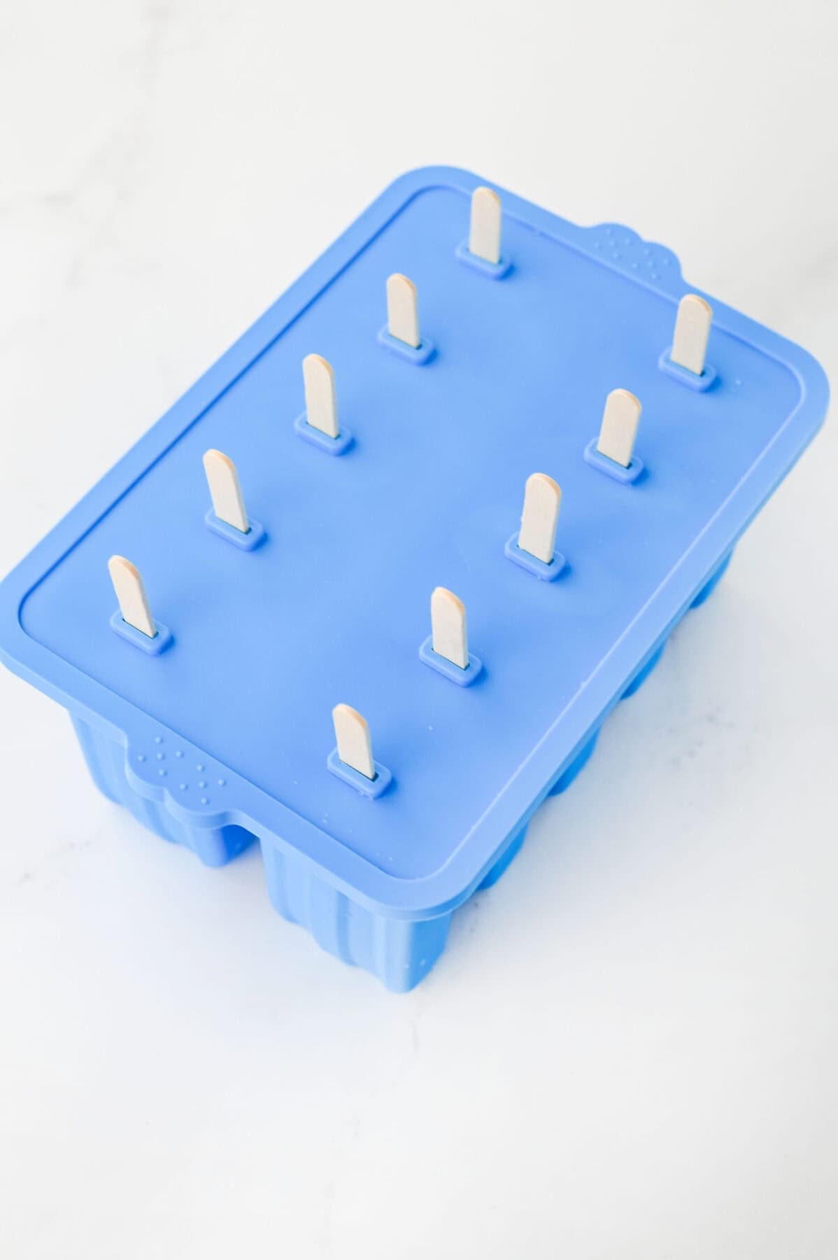 popsicle sticks added to pina colada popsicles