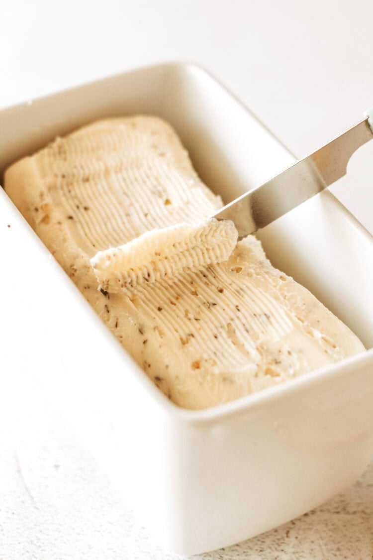 Garlic Butter in a white dish with a butter knife