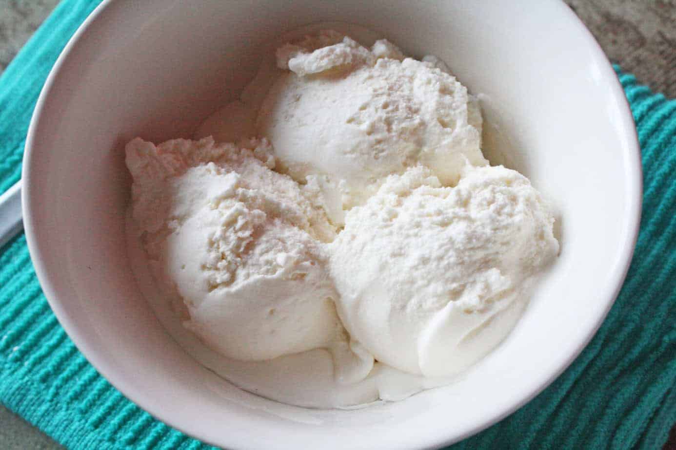 kitchenaid vanilla ice cream in a white bowl with a blue towel underneath