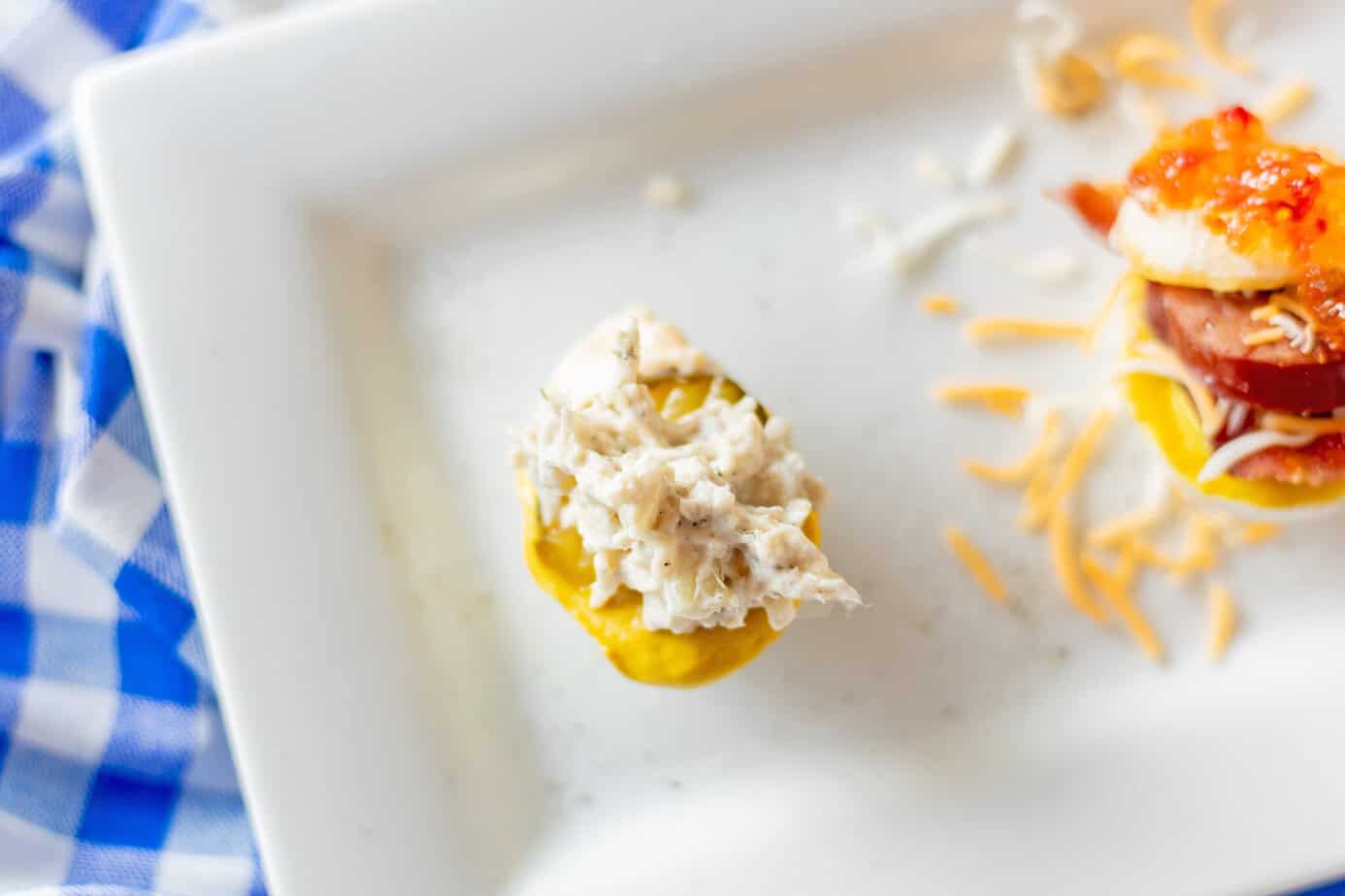 chicken salad on a pickle on an egg flight